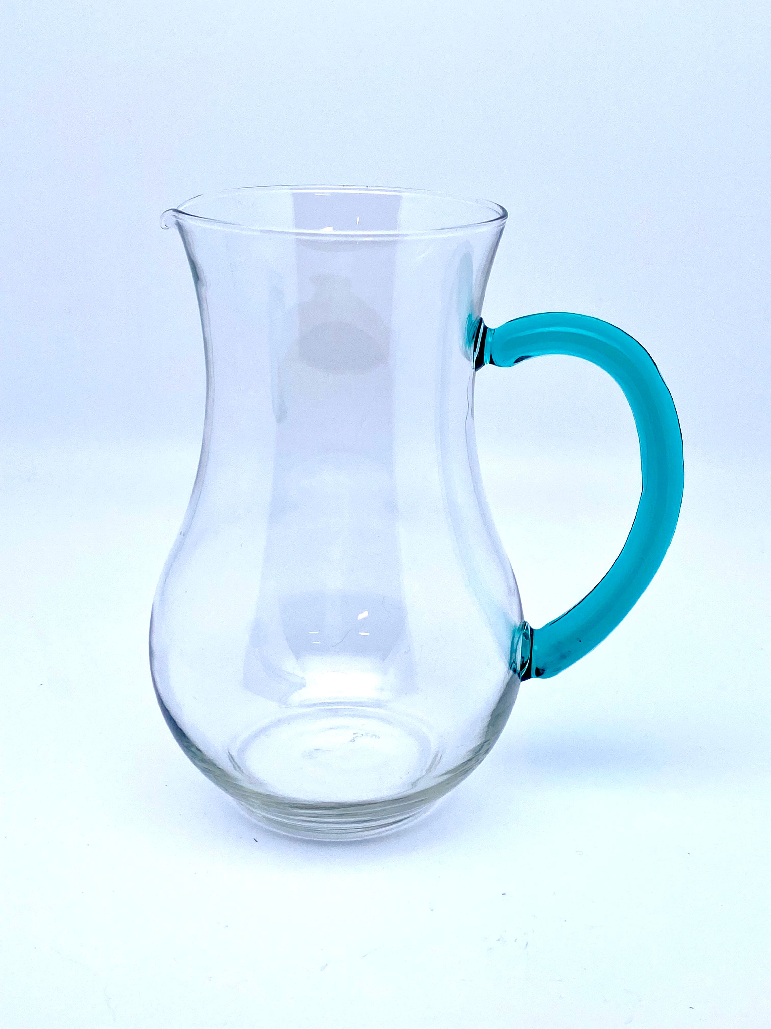 Transparent glass decanter and green handle