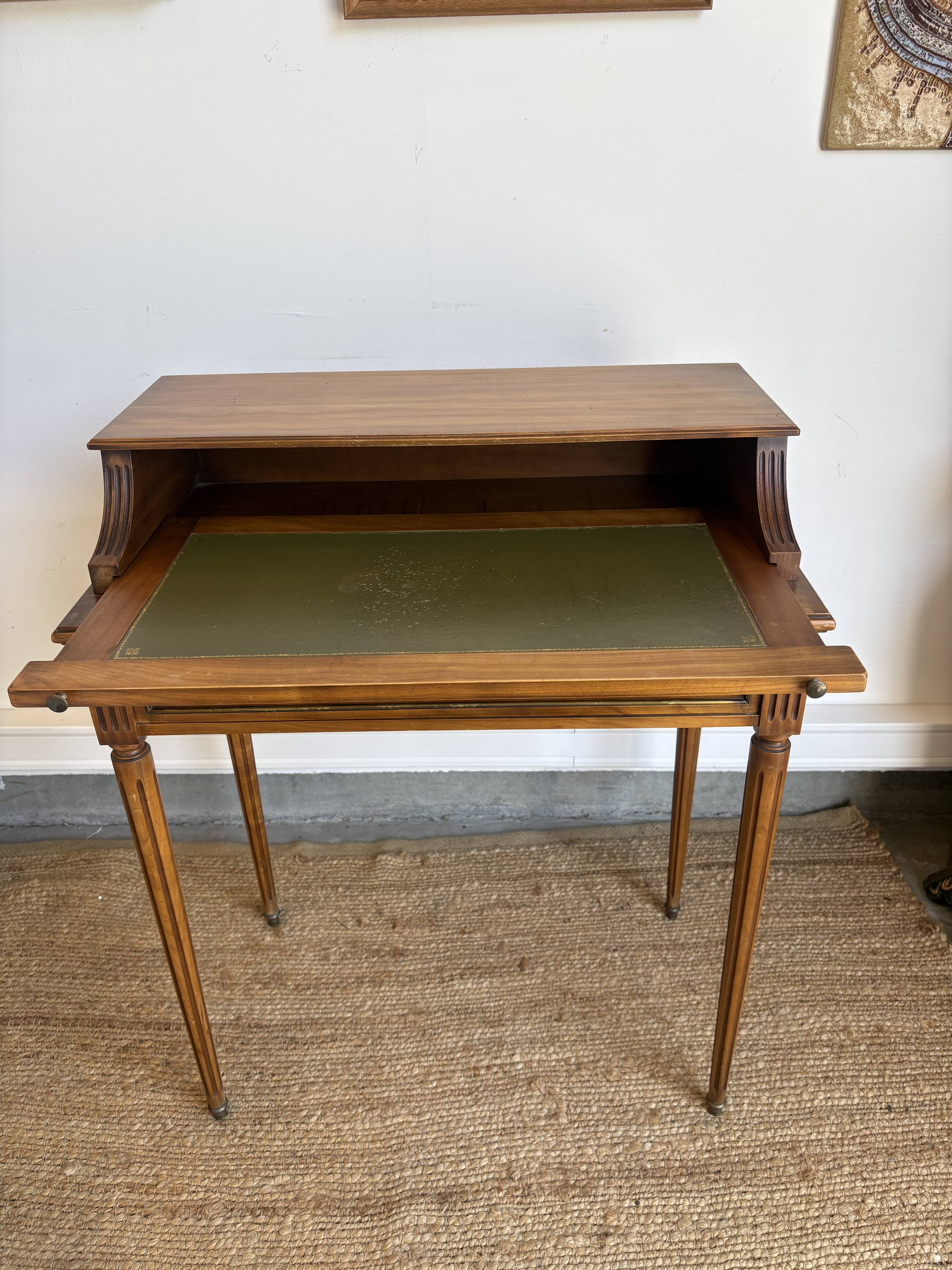 Louis XVI style mahogany telephone table with a green leather top.