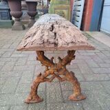 French country style cast iron bench with old rustic wooden plank