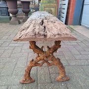 French country style cast iron bench with old rustic wooden plank