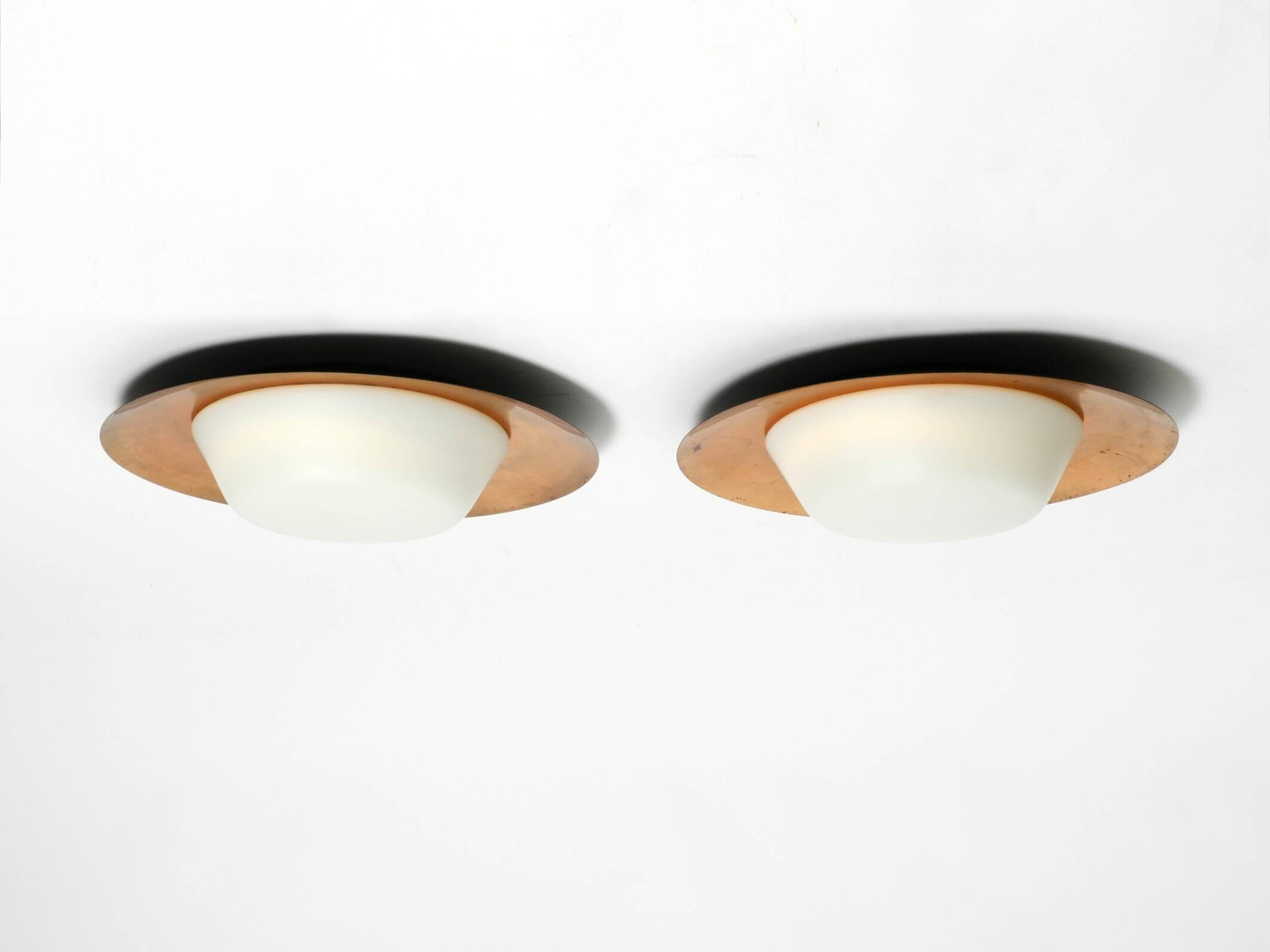 Pair of Mid Century wall or ceiling lamps made of glass with copper-plated