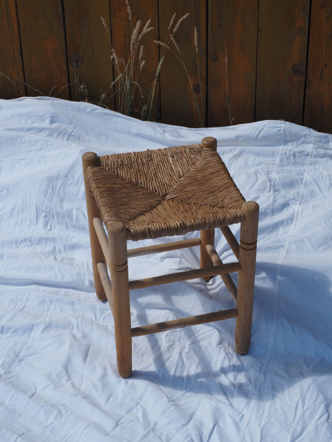 Farm stool made of wood and straw