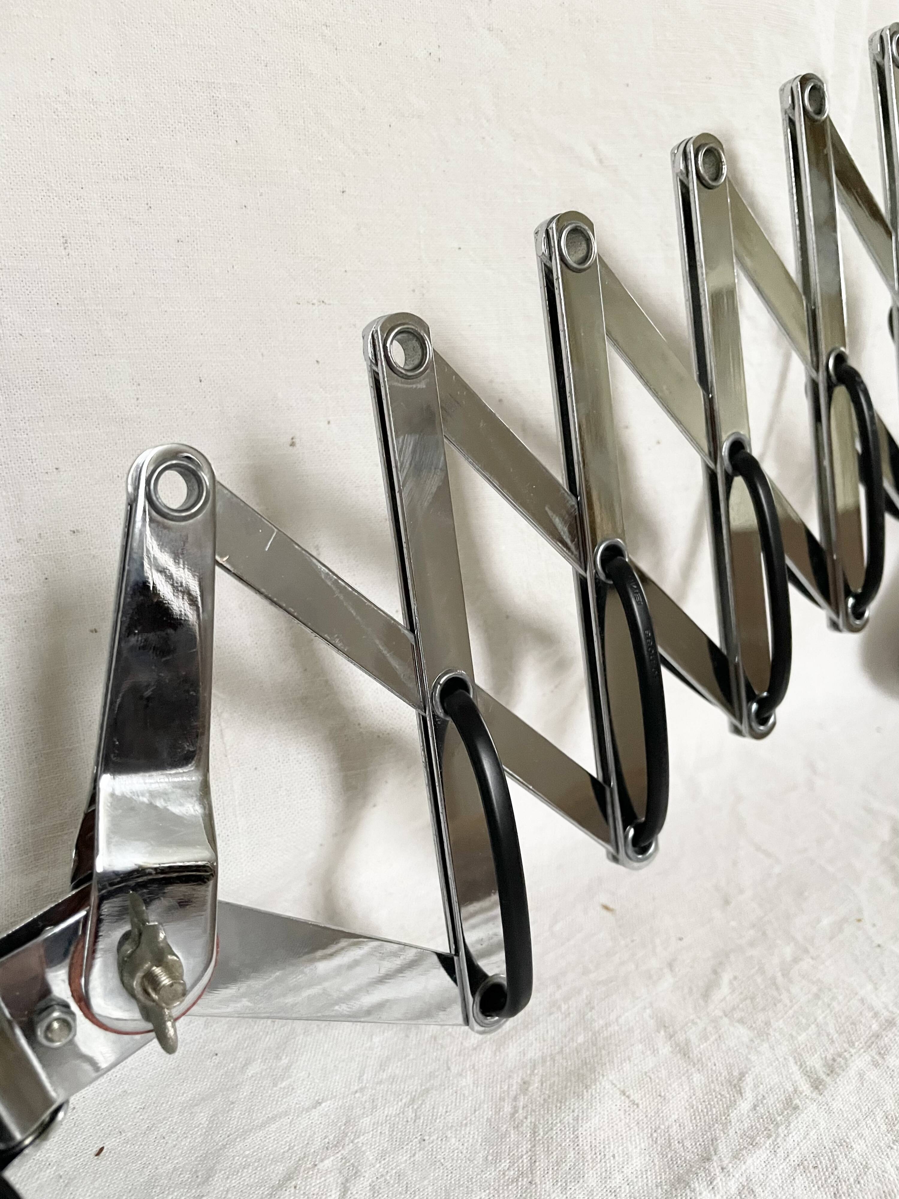 Vintage accordion wall light in chrome metal.