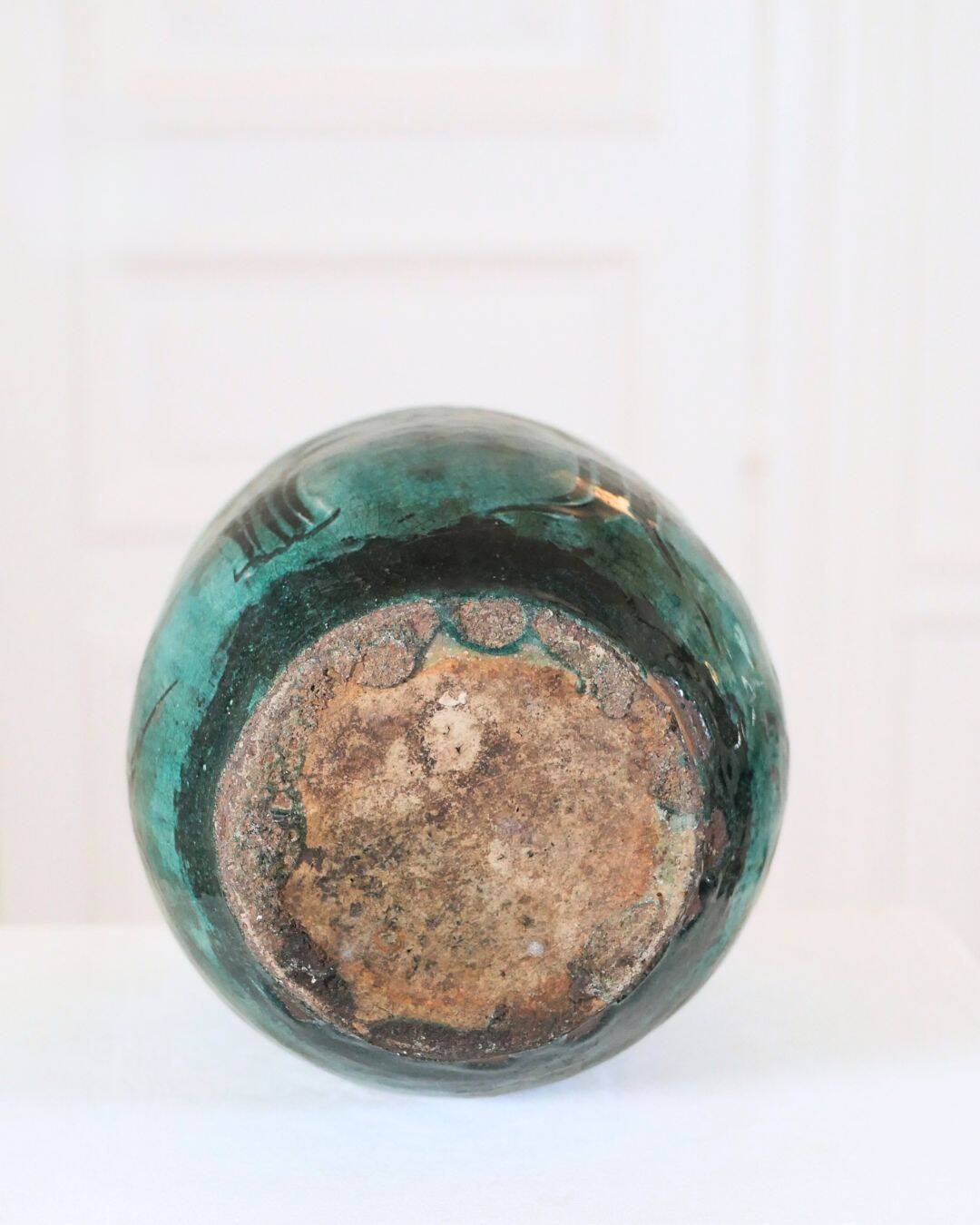 Chinese glazed earthenware vase with bird and flower decoration on a green background