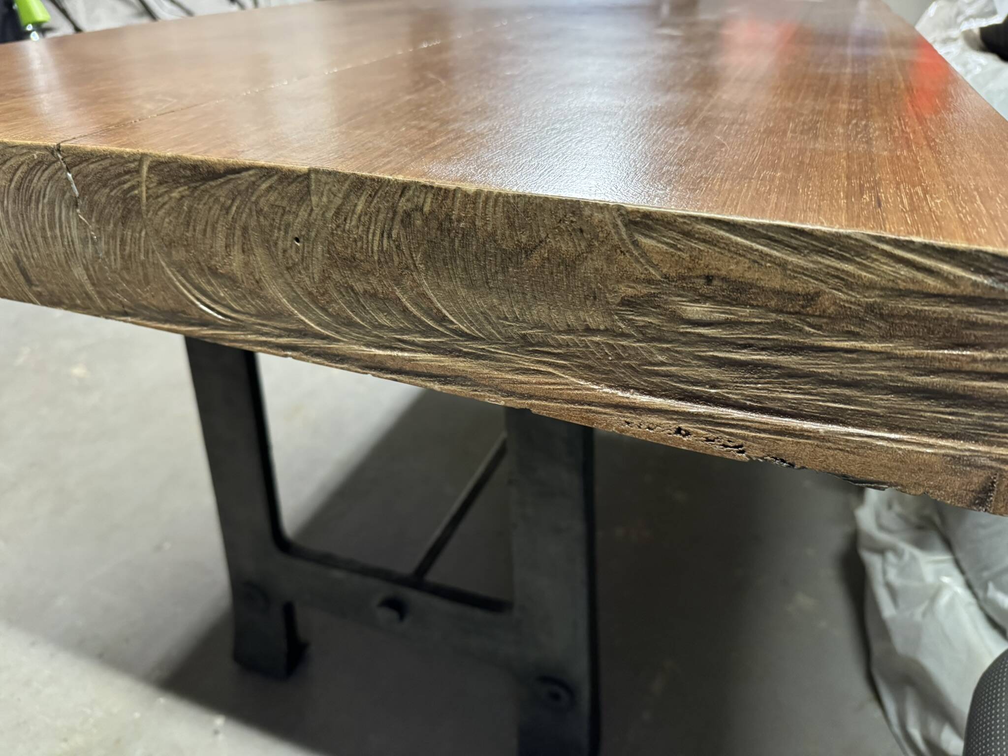 Industrial style table with a mahogany top.