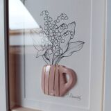 Composition of a bouquet of lily of the valley in a clay mug
