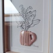 Composition of a bouquet of lily of the valley in a clay mug