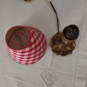 Pair of small lamps in gilded bronze by Petitot and red gingham lampshades.