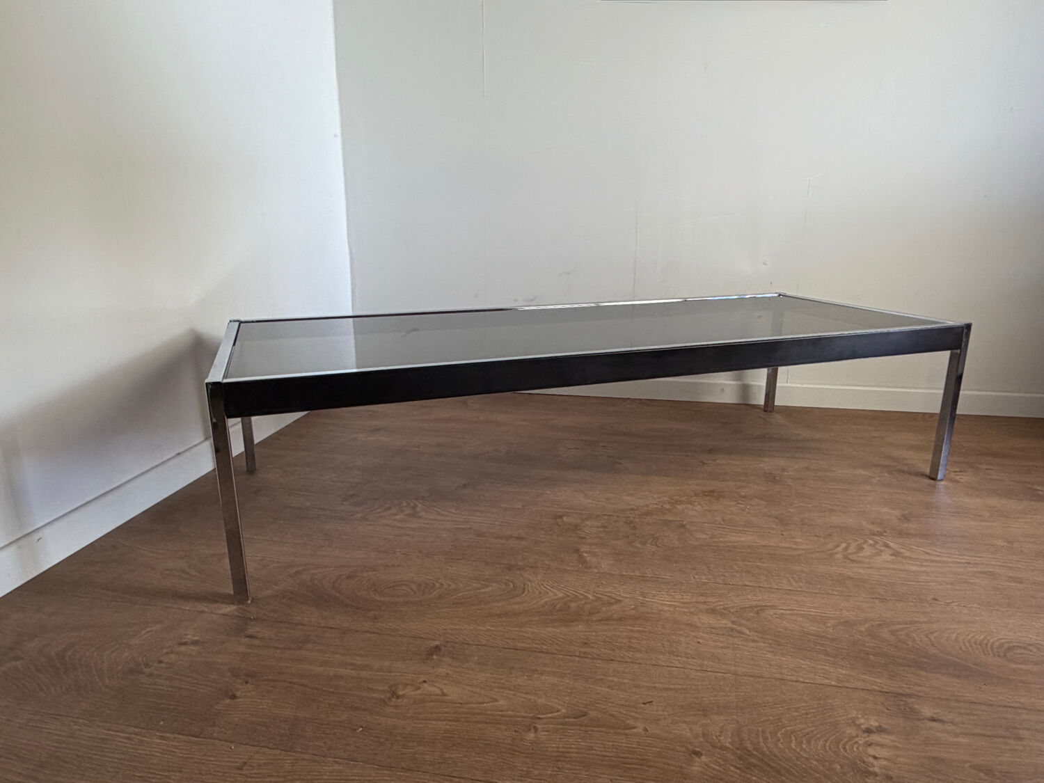 Large designer coffee table from the 70s in chrome, smoked glass, and faux leather.