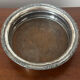 Antique silver-plated bottle coaster with floral decoration.