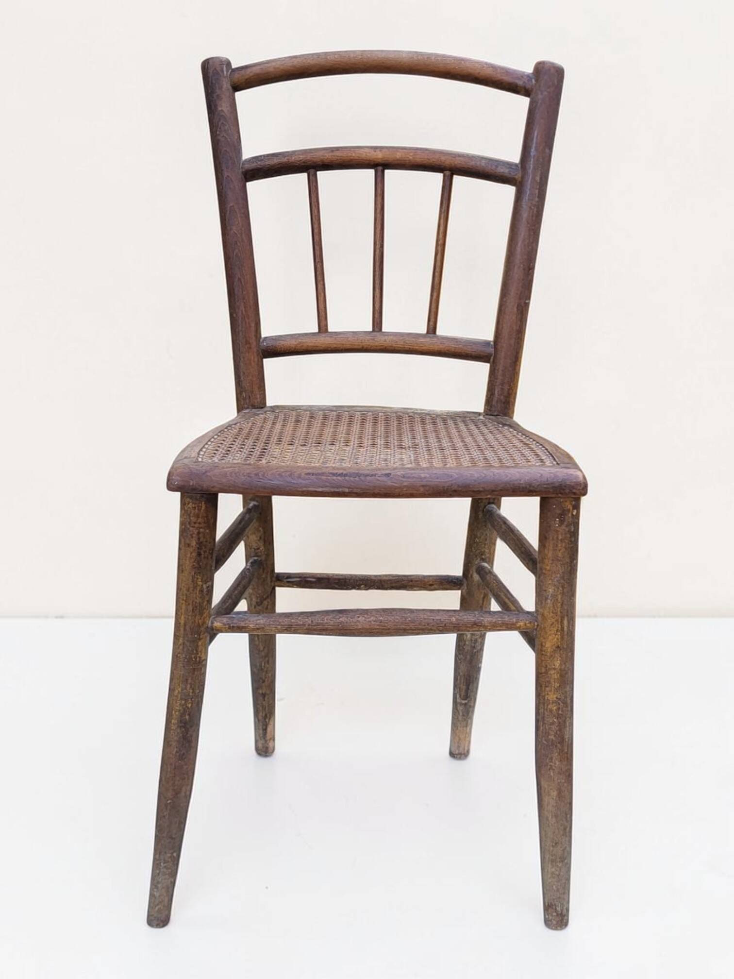 Chair with a slatted backrest and caned seat.