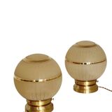 Pair of large art deco globe table lamps with brass legs