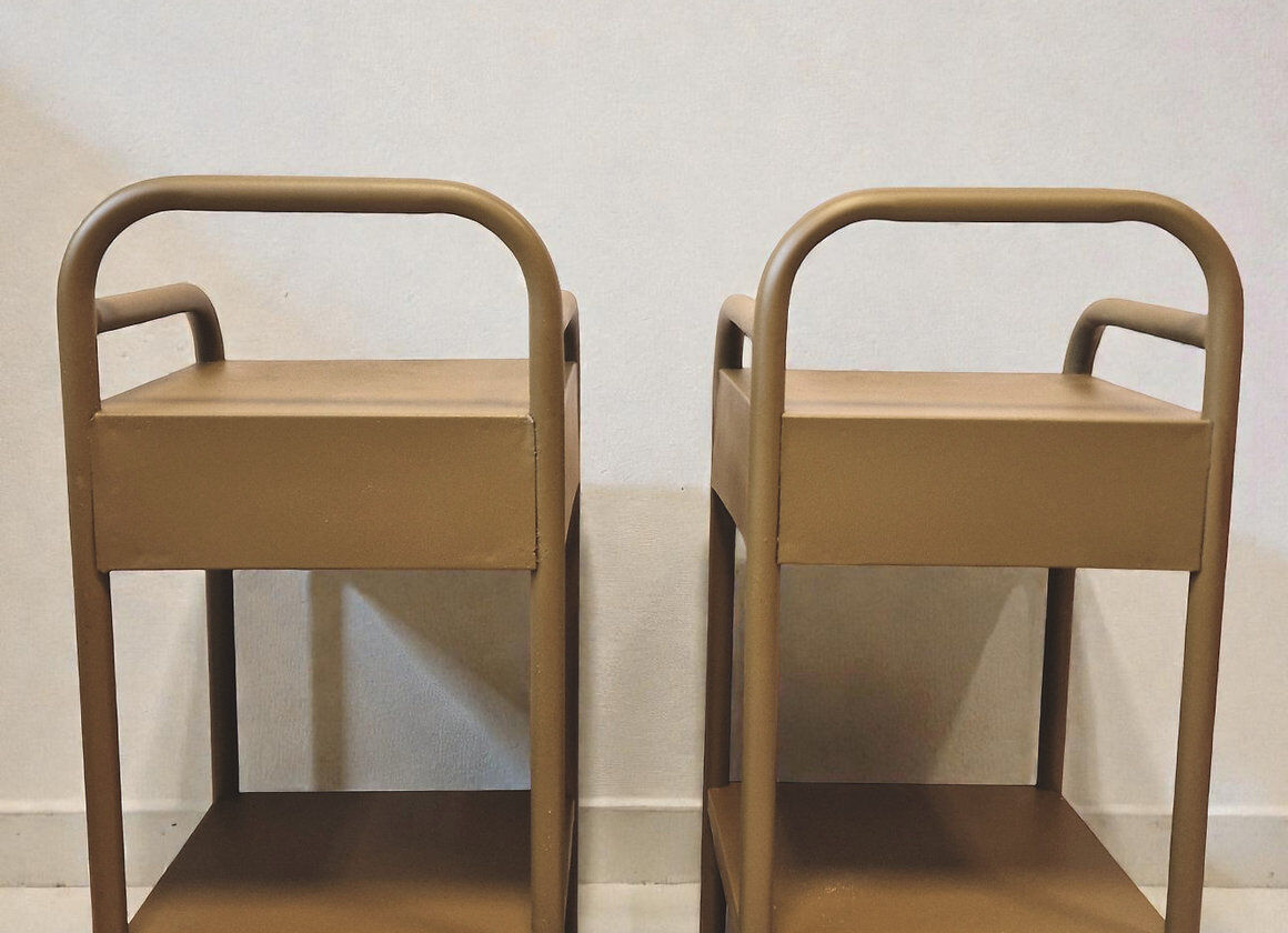 Old ochre metal bedside tables from a boarding school.