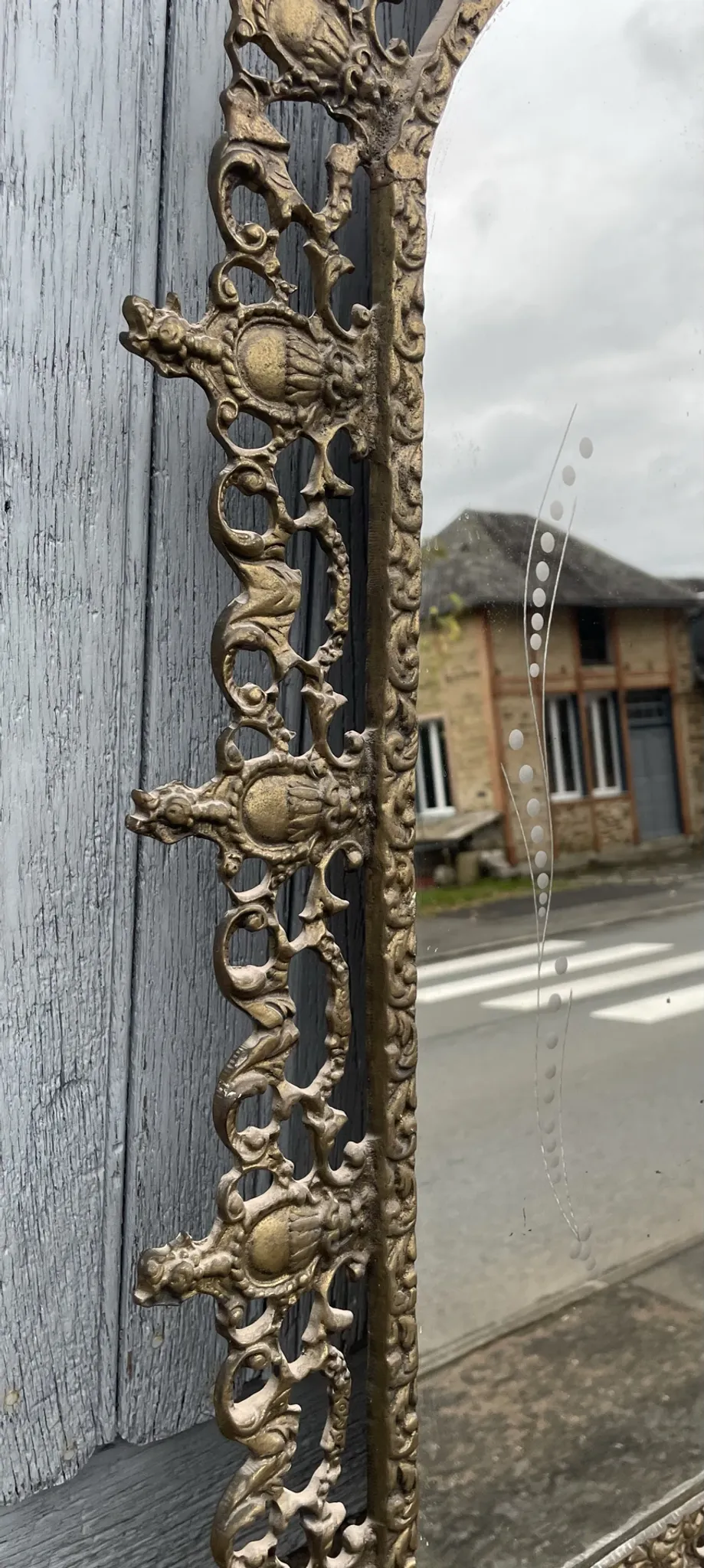 Vintage brass wall mirror adorned