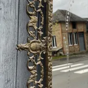 Vintage brass wall mirror adorned