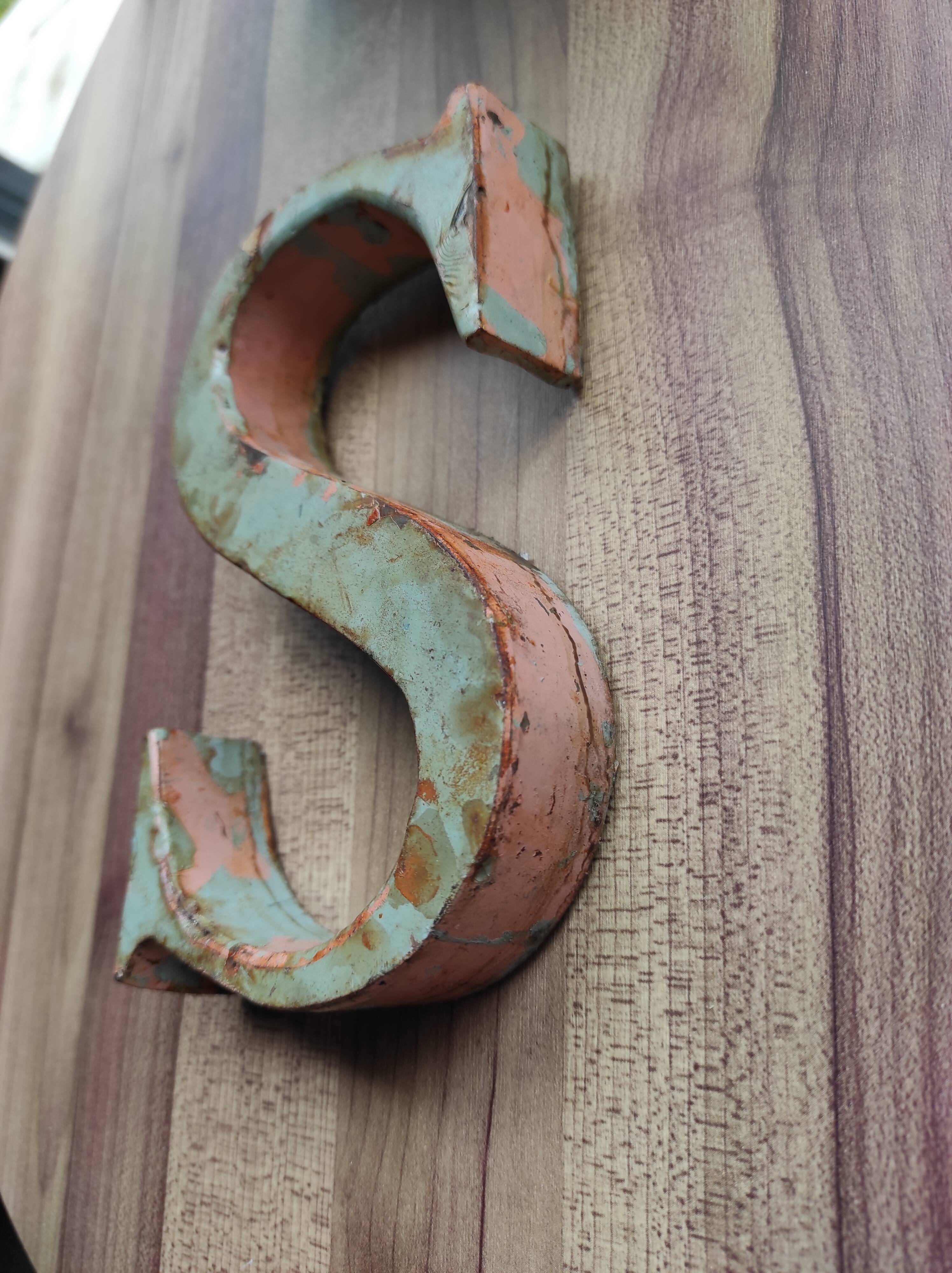 Old sign letter "S" in patinated metal