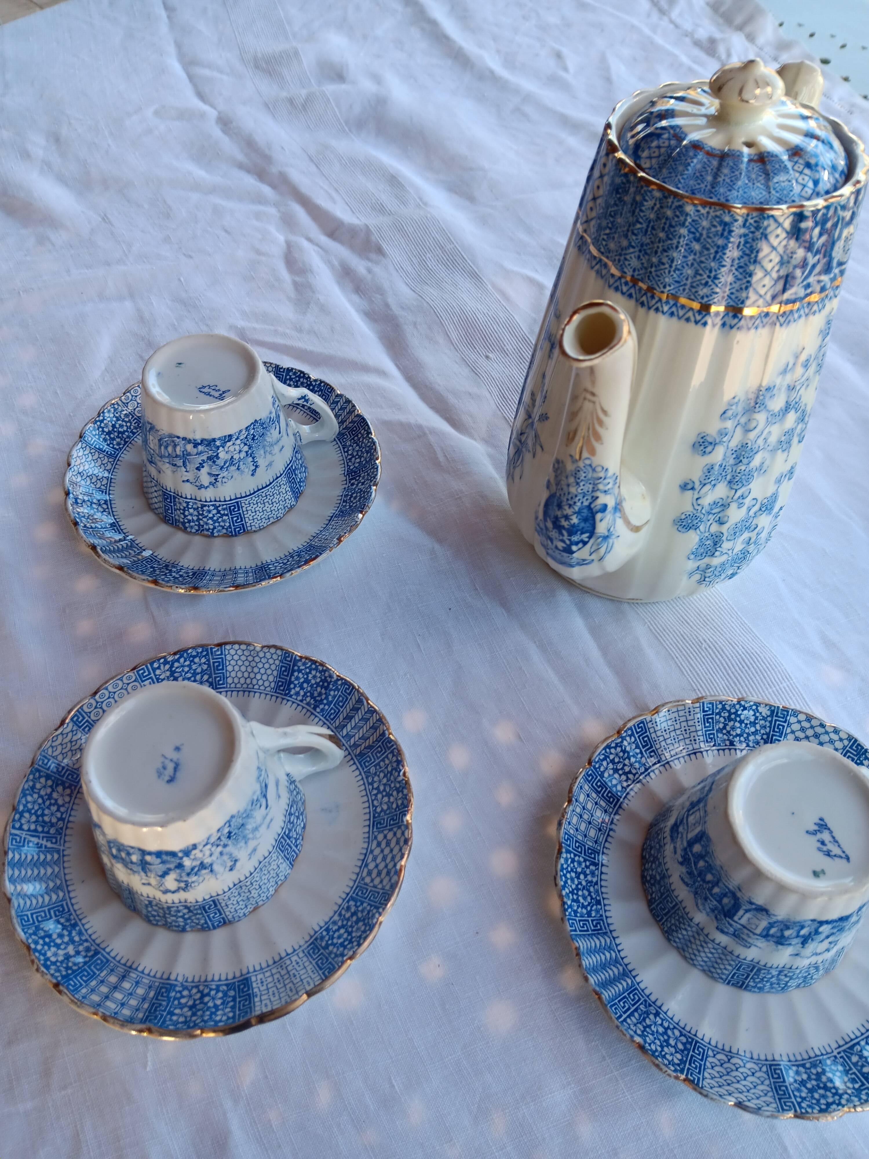Old coffee service Lunéville with blue lace decoration.