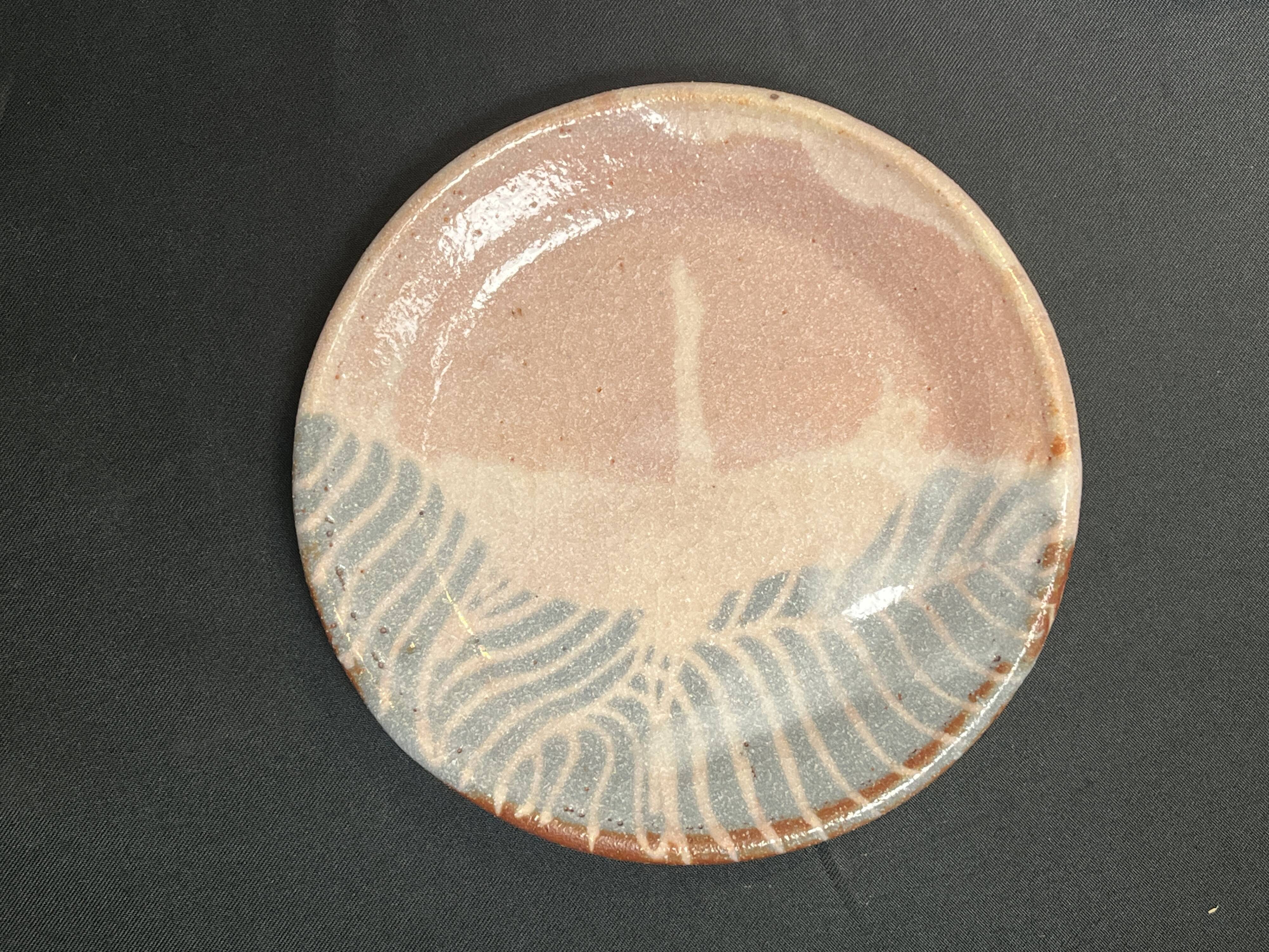 Set of five small Korean stoneware plates with pink crane, 20th century