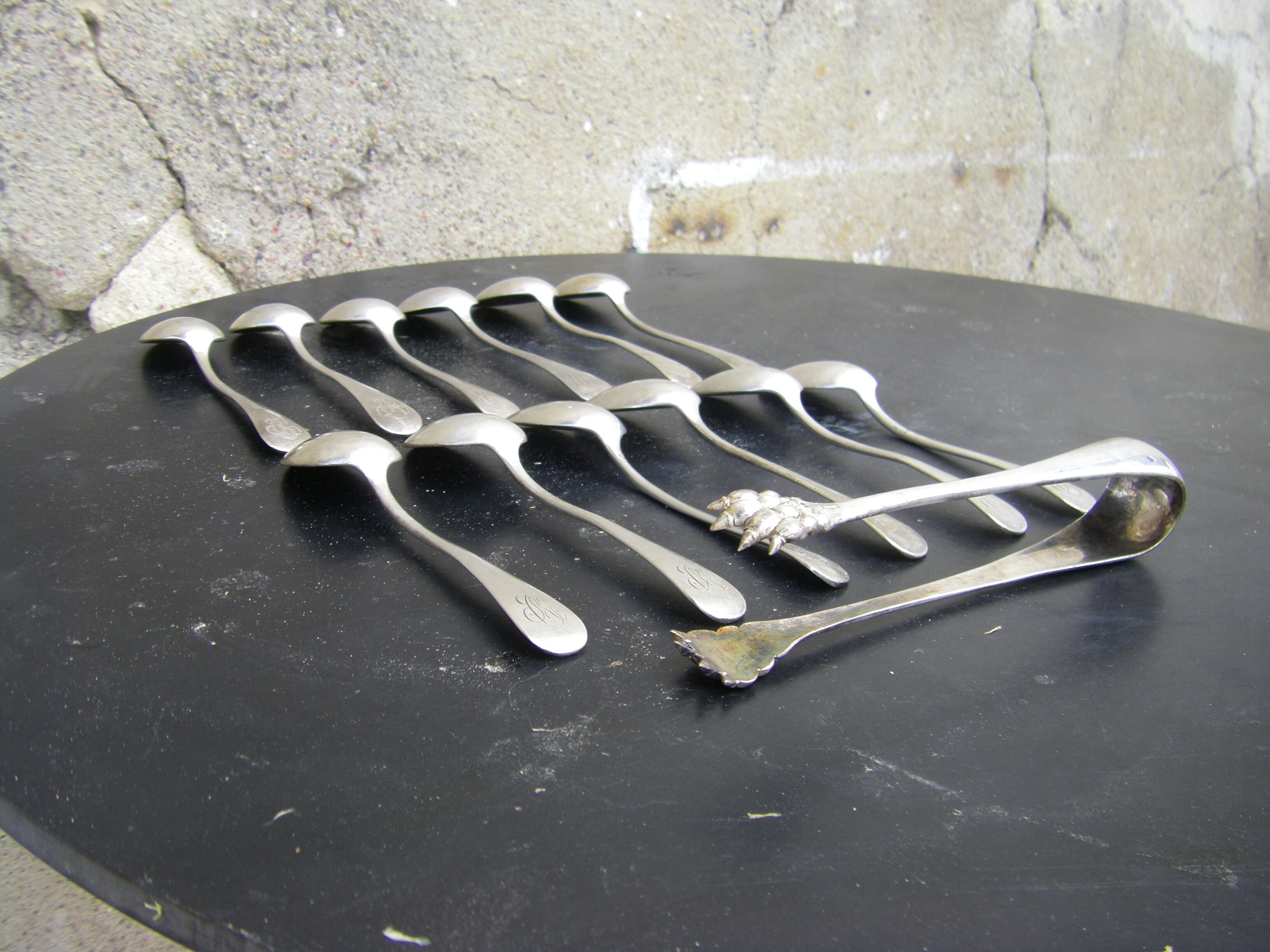 Set of twelve teaspoons and a sugar tongs