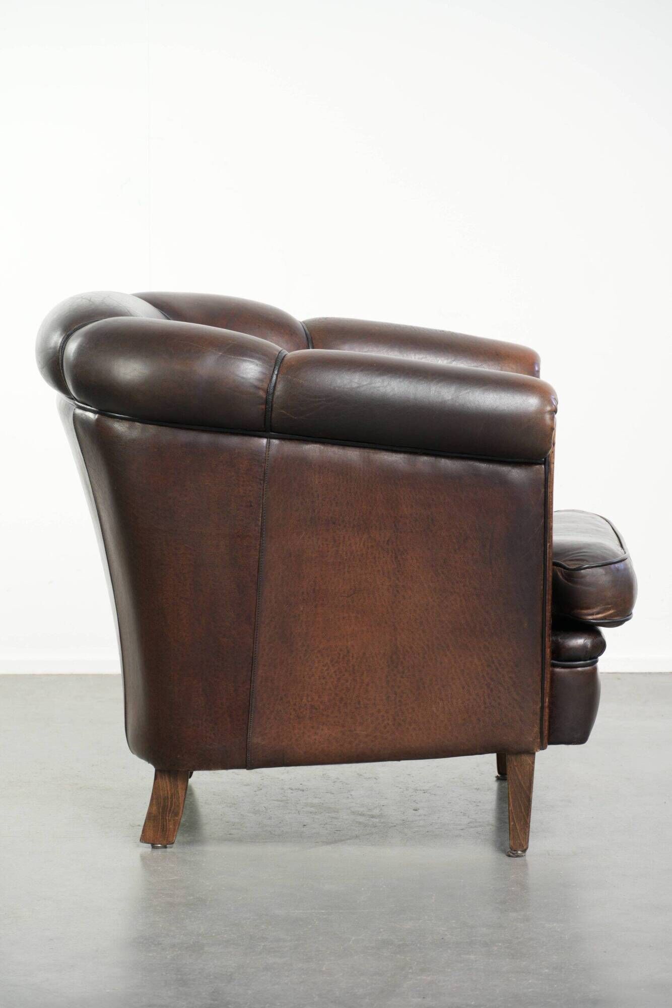Set of a sheepskin sofa together with its matching club armchair