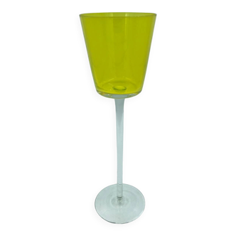 Yellow glass candlestick on a stand