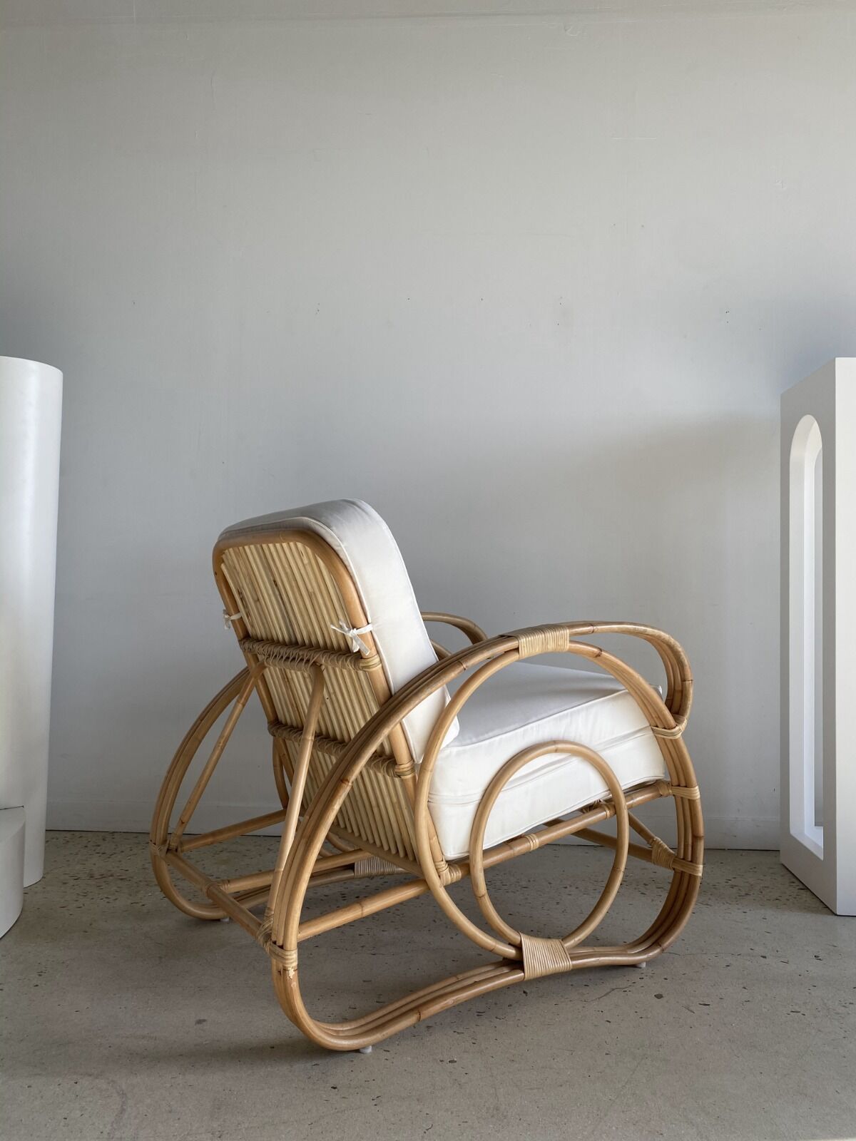 Large rattan rest chair and white cushions