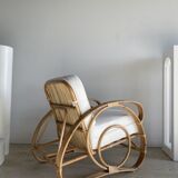 Large rattan rest chair and white cushions