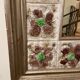 Large square ceramic mirror with floral decoration.