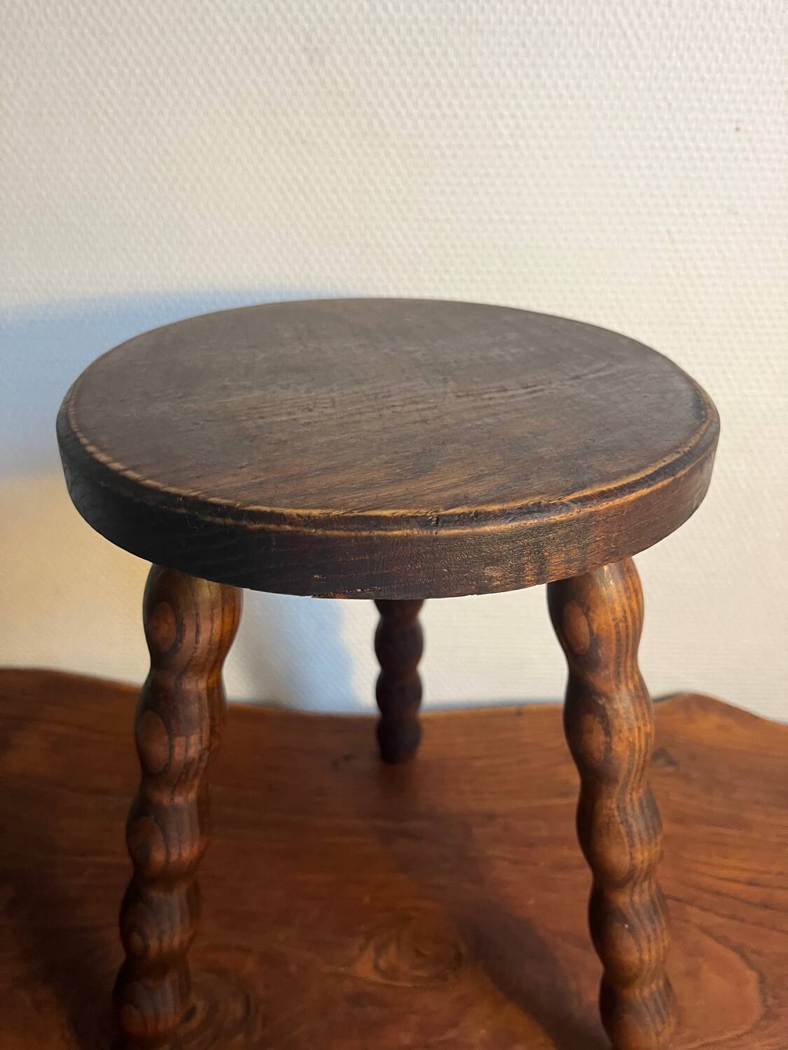 Round wooden tripod stool