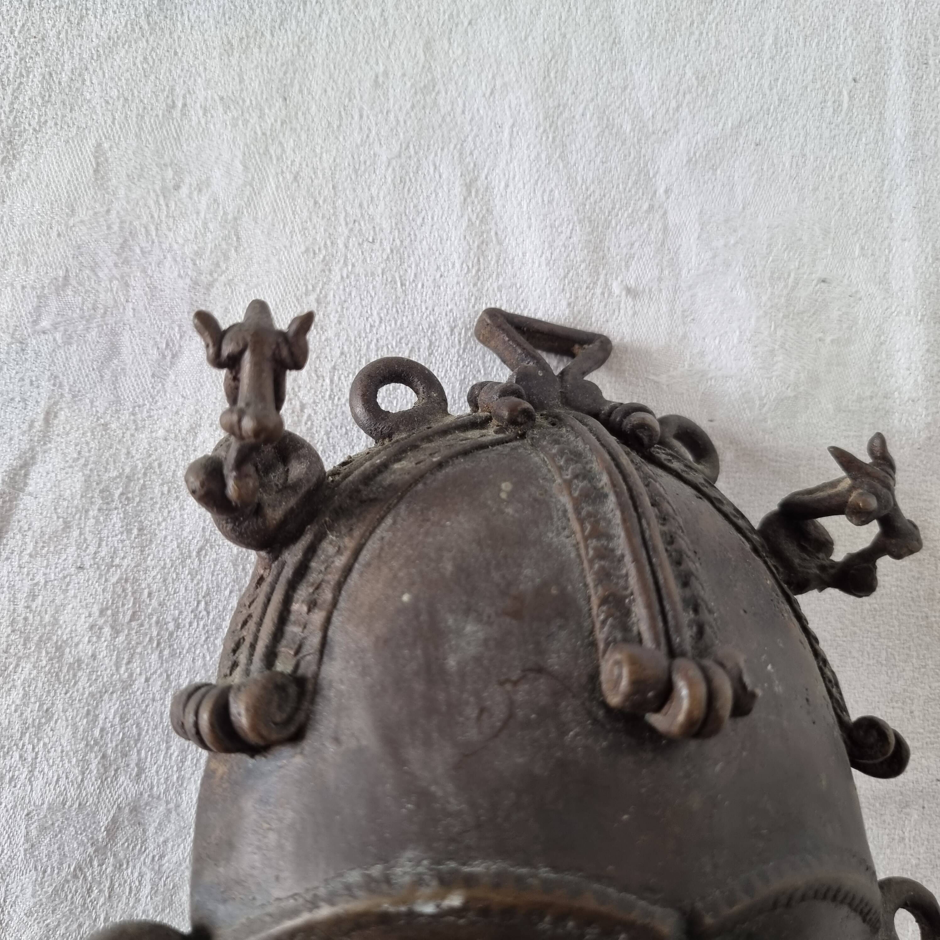 African bronze mask on pedestal, from Ivory Coast, dating