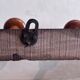 Wall-mounted coat rack with 8 turned wooden hooks in faux bamboo style.