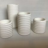 Four white earthenware candle holders