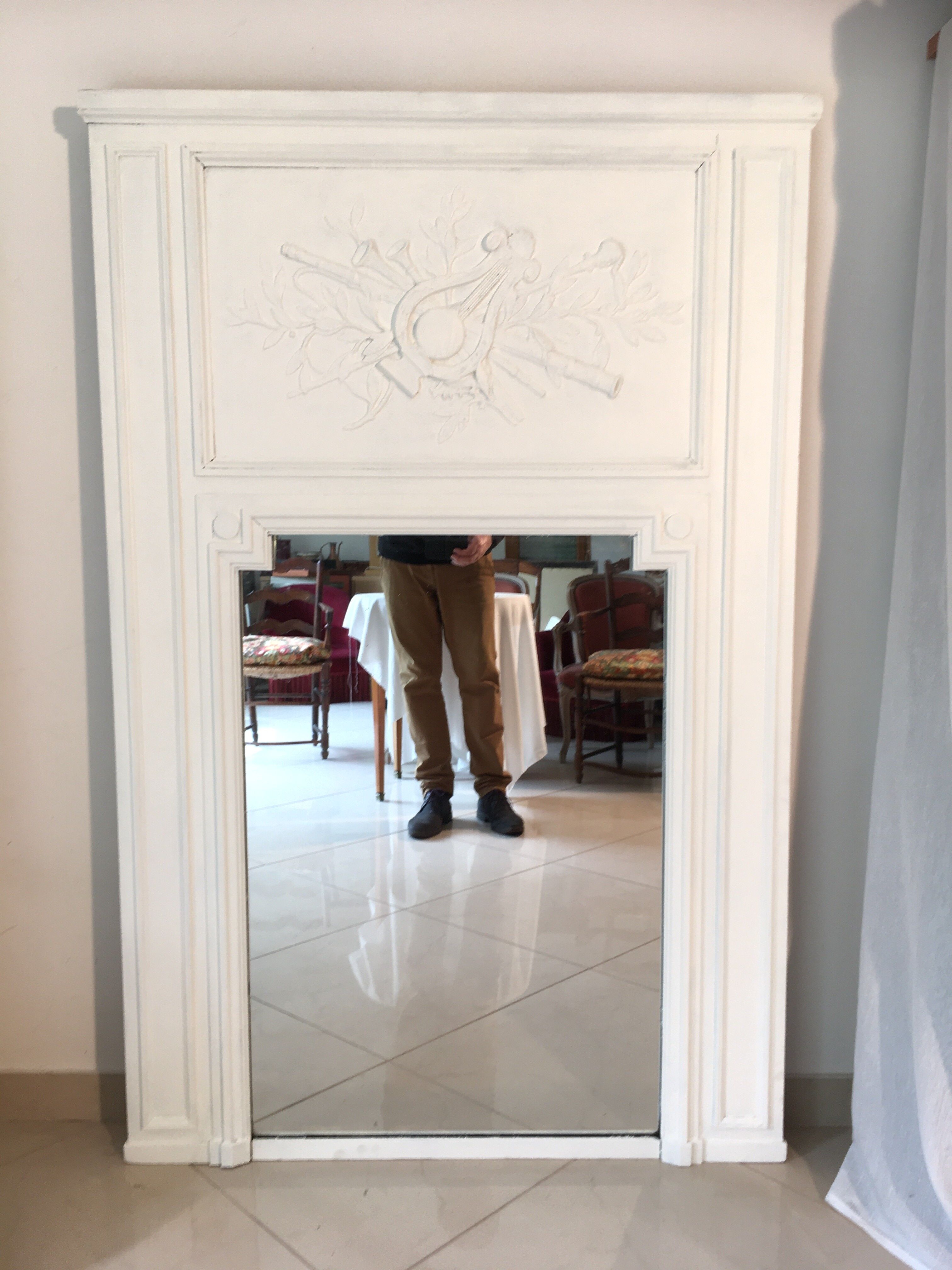 Fireplace trumeau mirror decorated with the attributes of music
