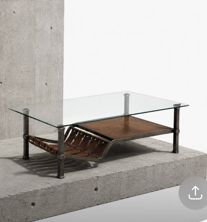 Brutalist coffee table in wrought iron and leather.