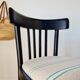 Curved black wooden bistro chair with striped seat