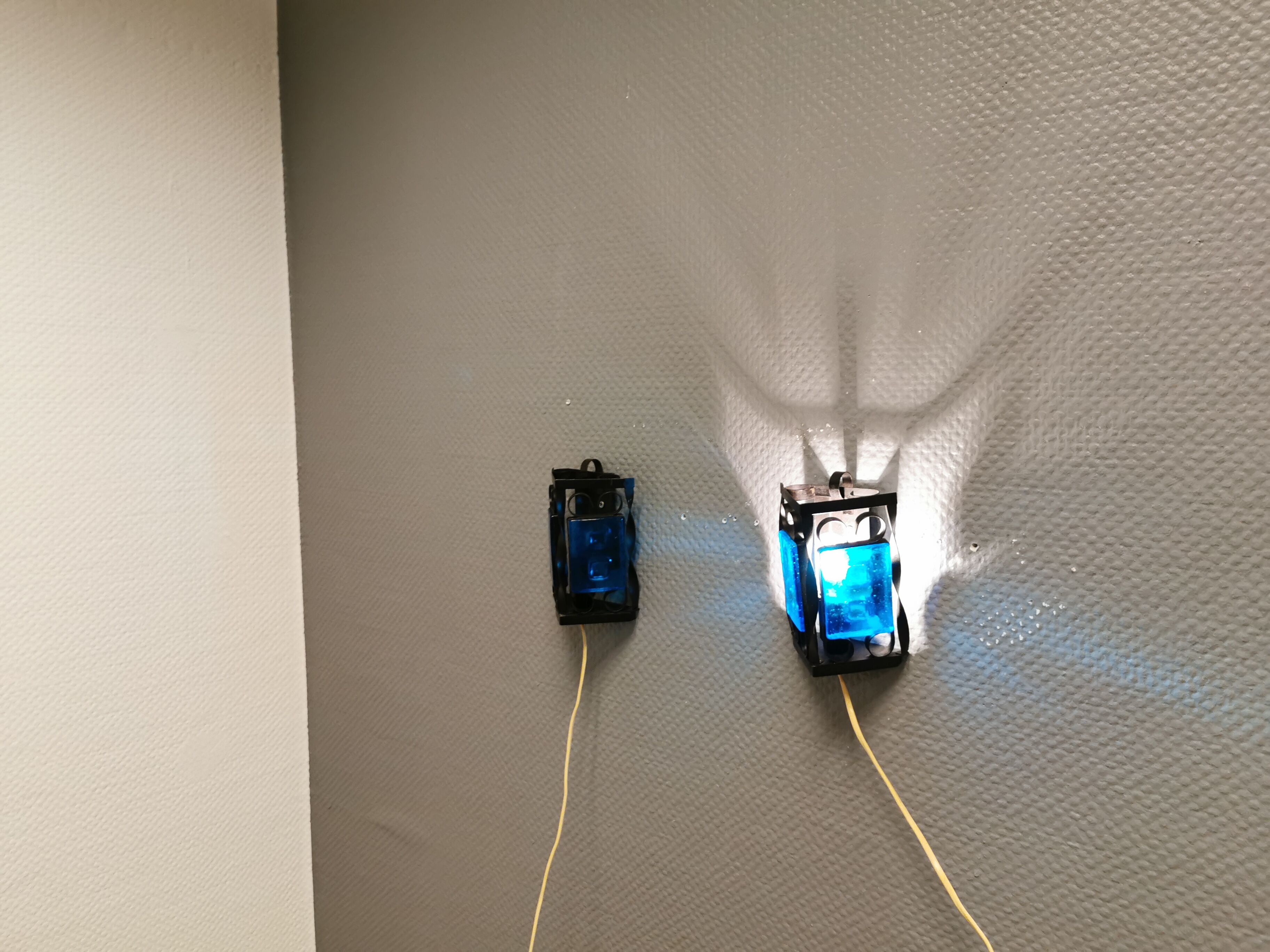 Wall lamps made of black cast iron and handmade thick pressed blue glass