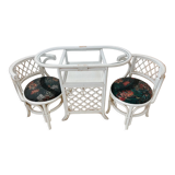 Rattan head-to-head table with vintage armchairs