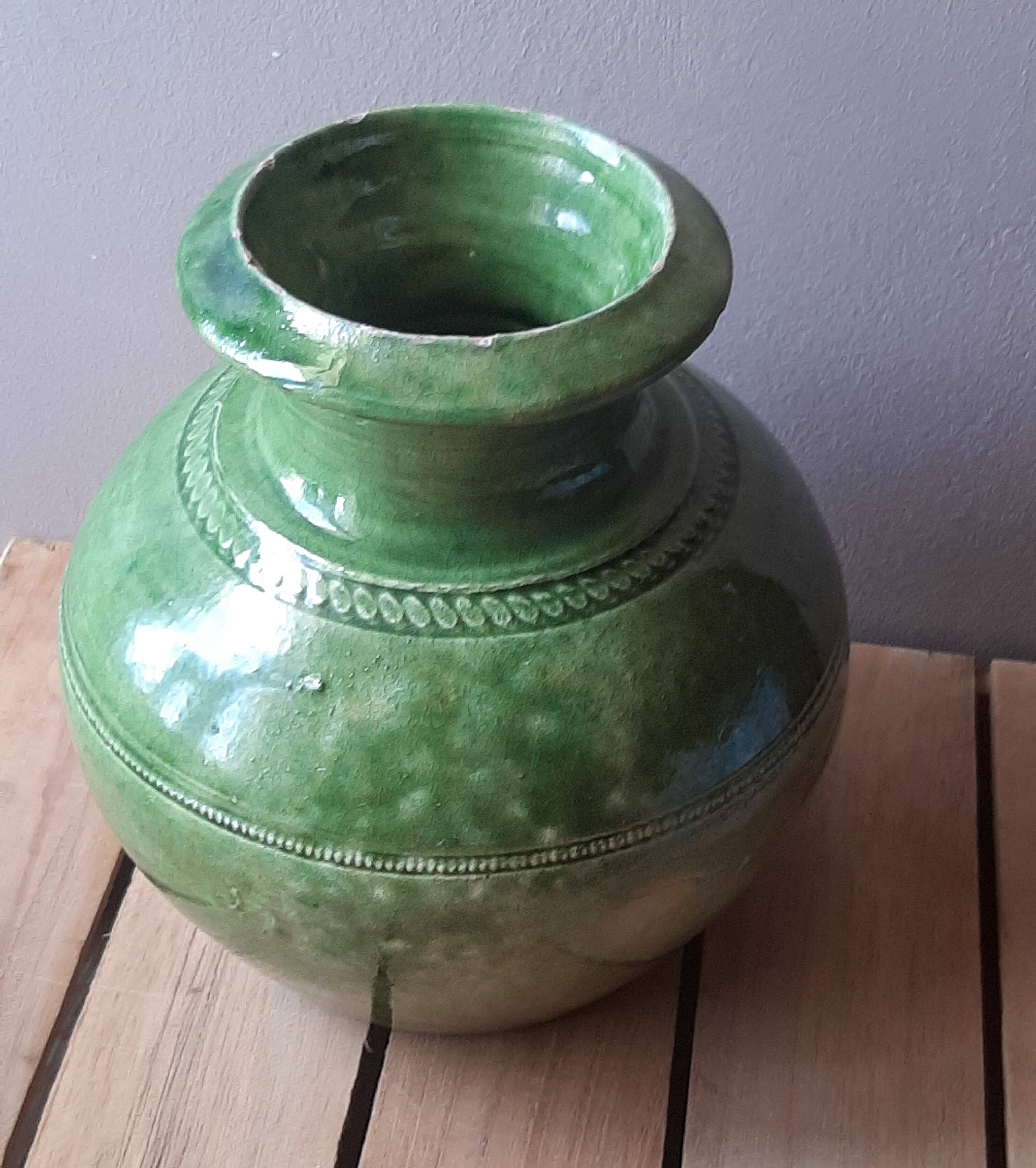 Ancient vase in glazed terracotta with green glaze.
