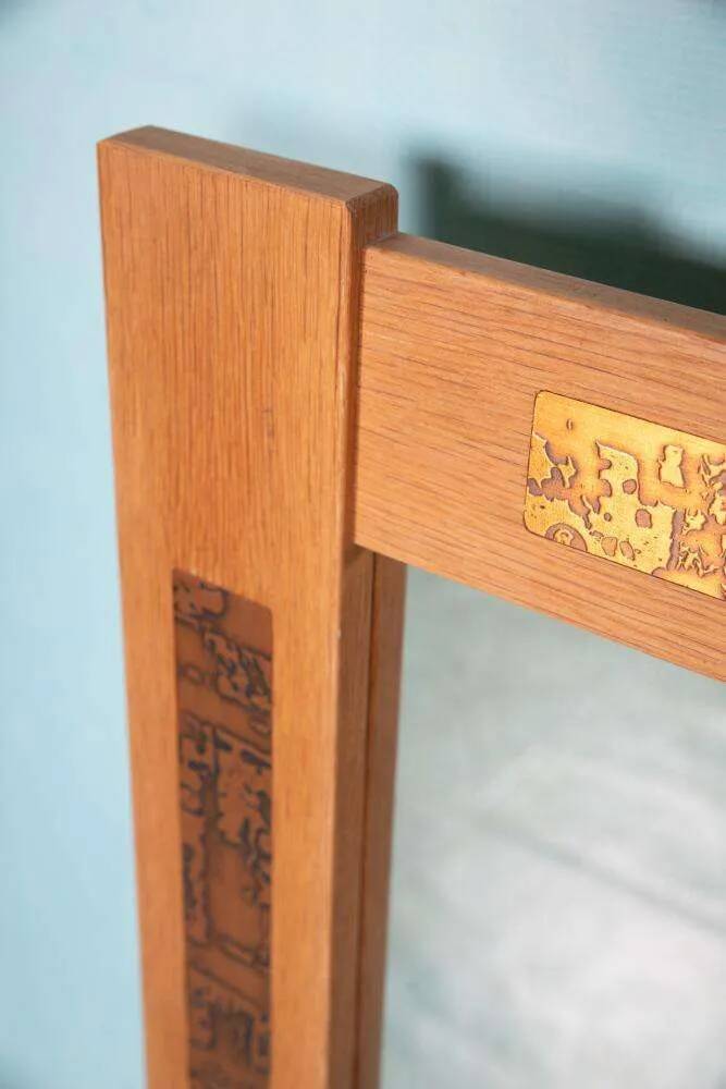 Vintage Danish wall mirror design from the 1960s in oak and stamped brass.