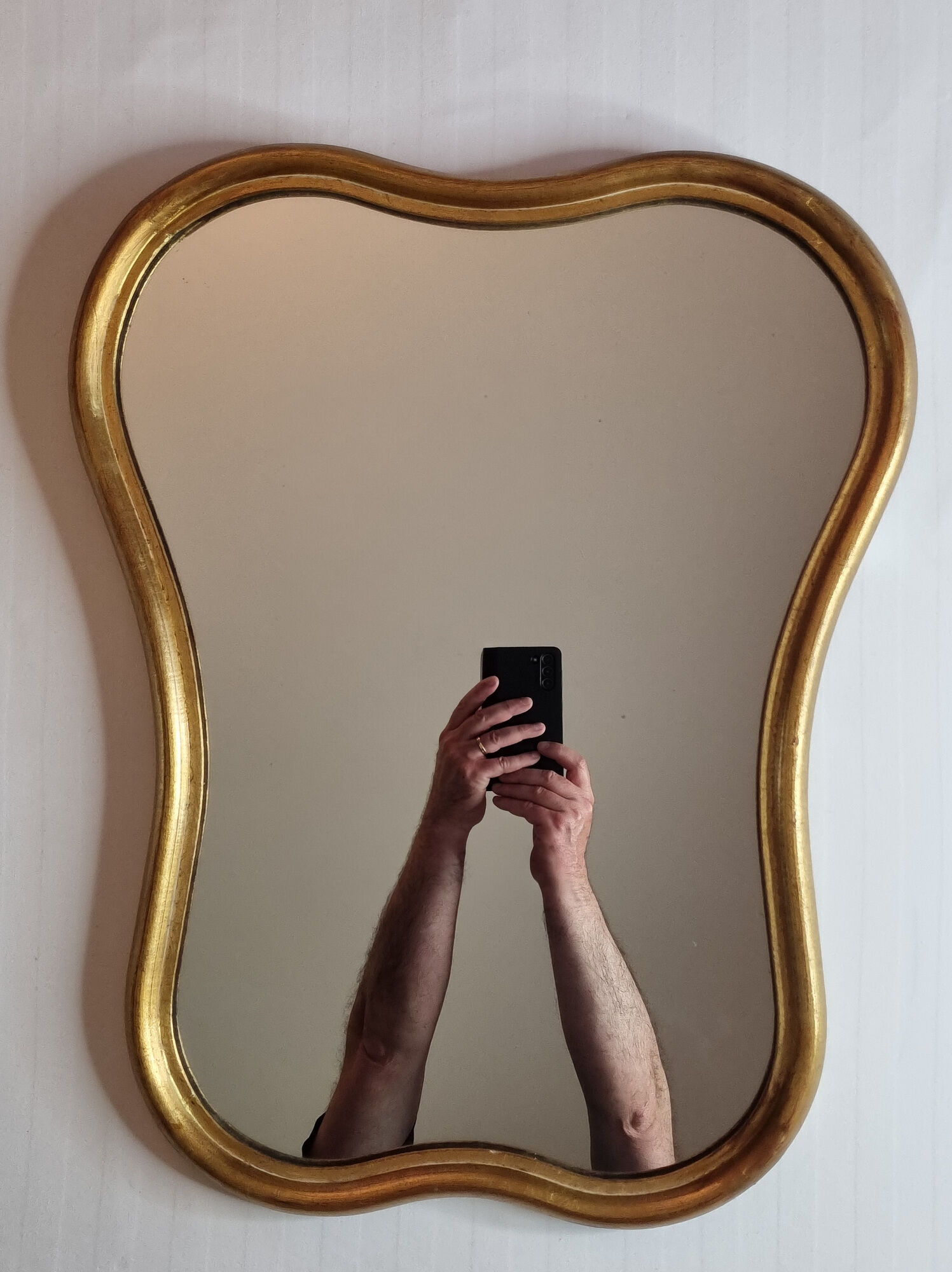 Vintage baroque style mirror, with curved frame in stucco and gilded wood 57 cm