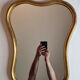 Vintage baroque style mirror, with curved frame in stucco and gilded wood 57 cm