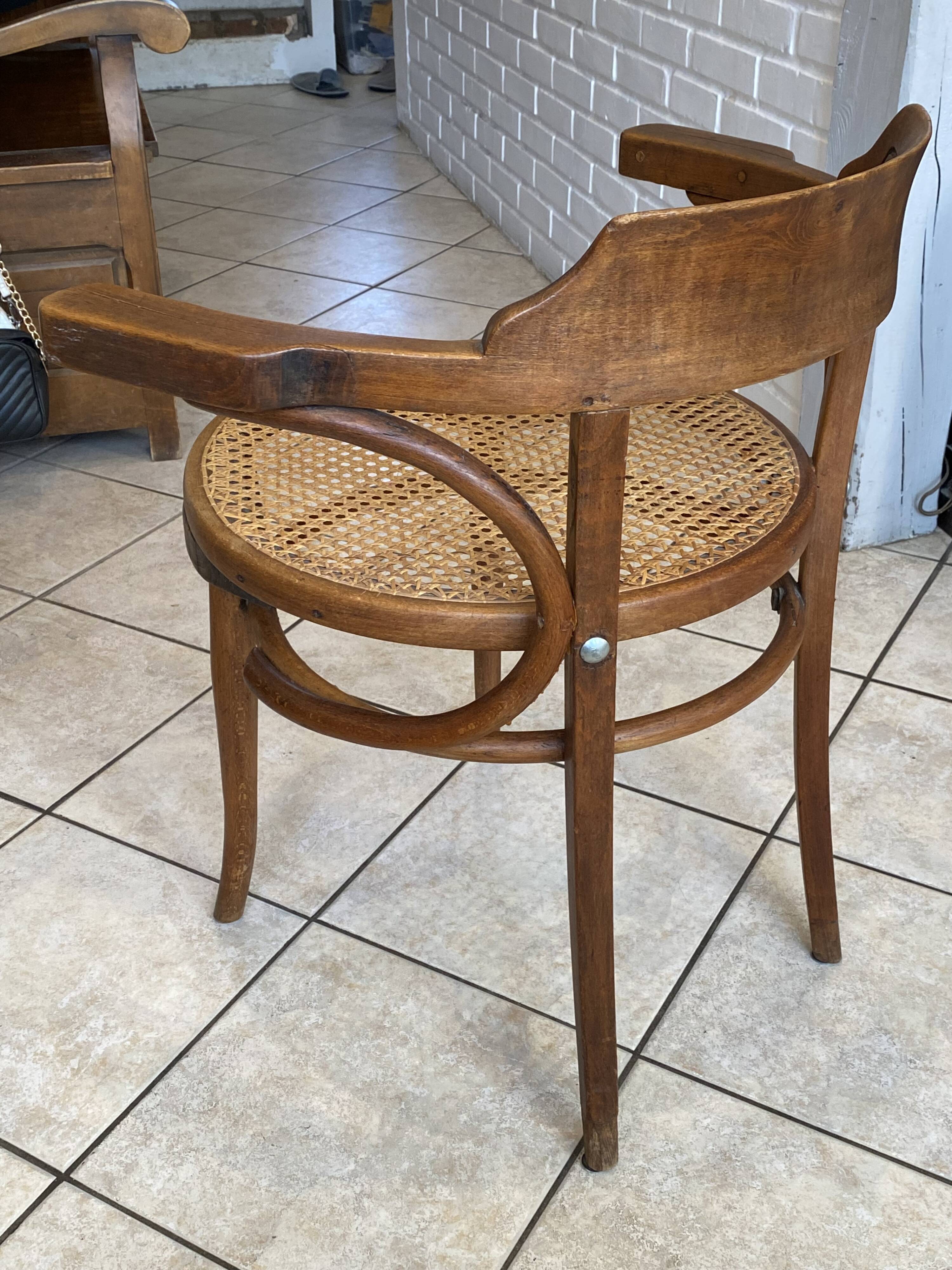 Bistro chair with a curved wooden frame and caned seat from the 1930s.