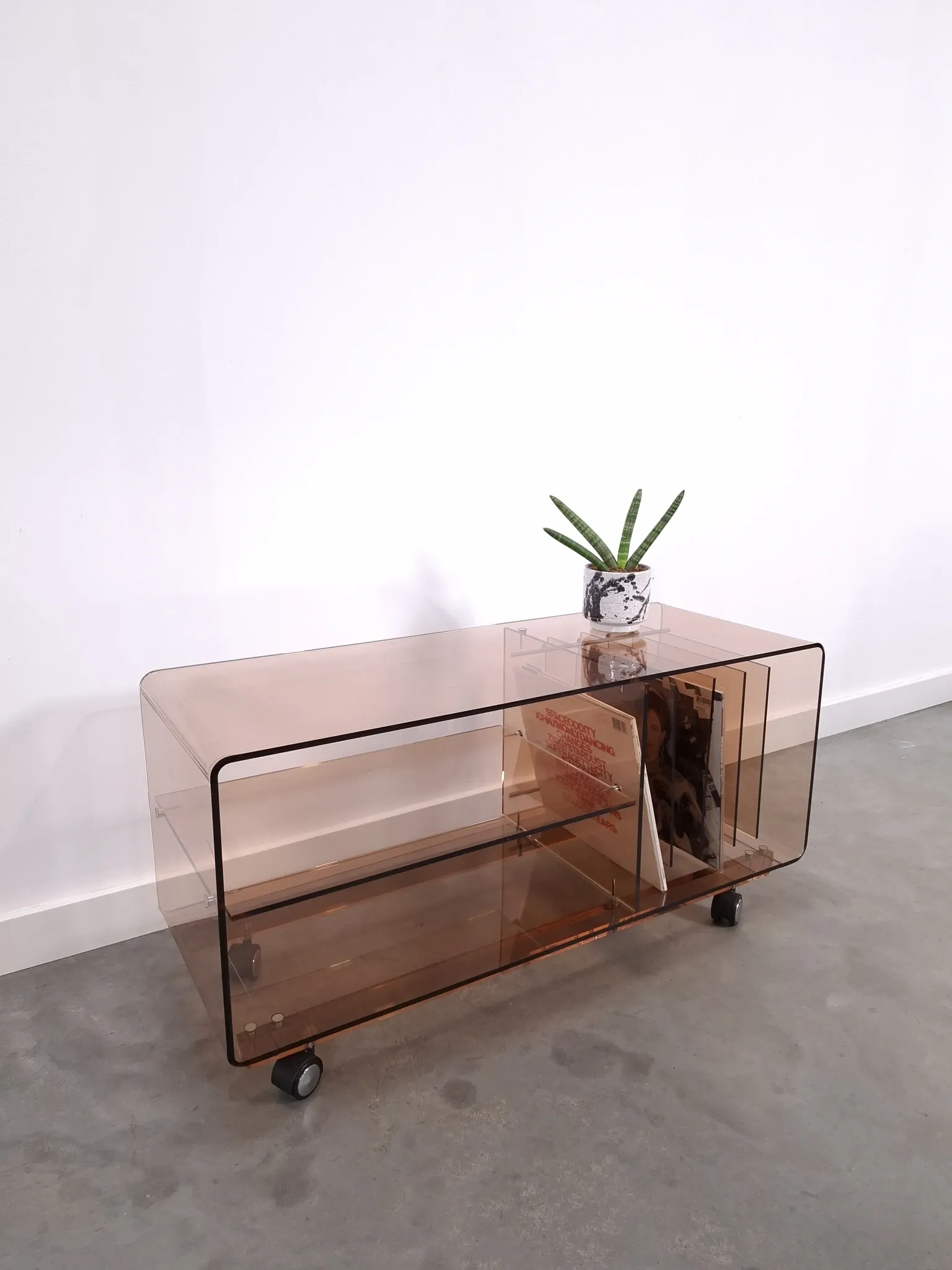 Vintage hifi, LP cabinet, TV unit made of tinted plexiglass on wheels, records.
