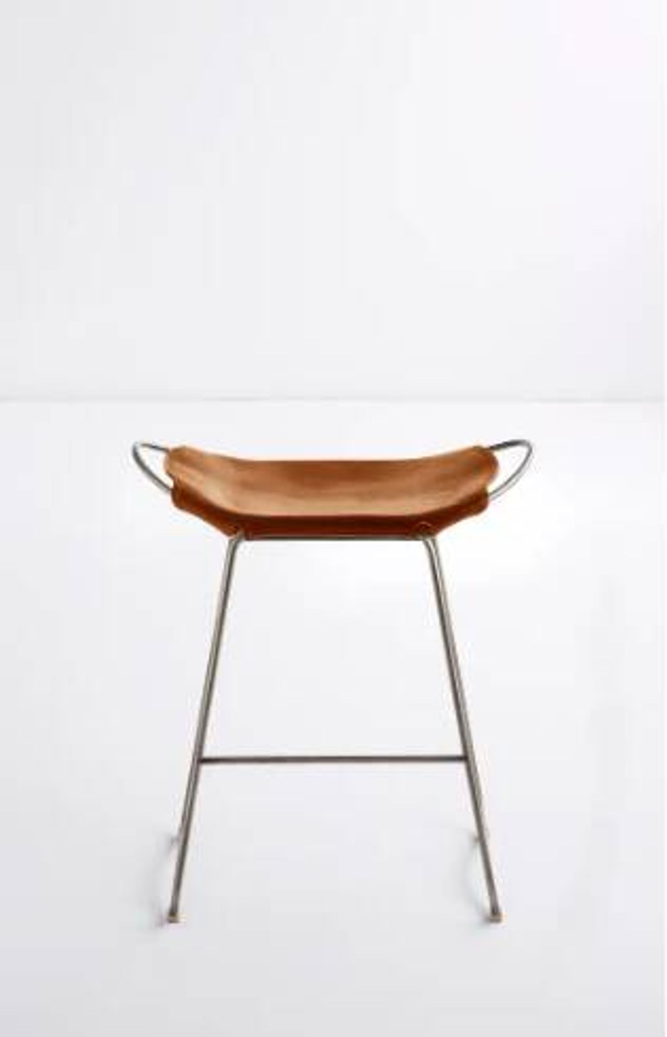 Contemporary bar stool with organic design in aged silver metal and natural tobacco leather.
