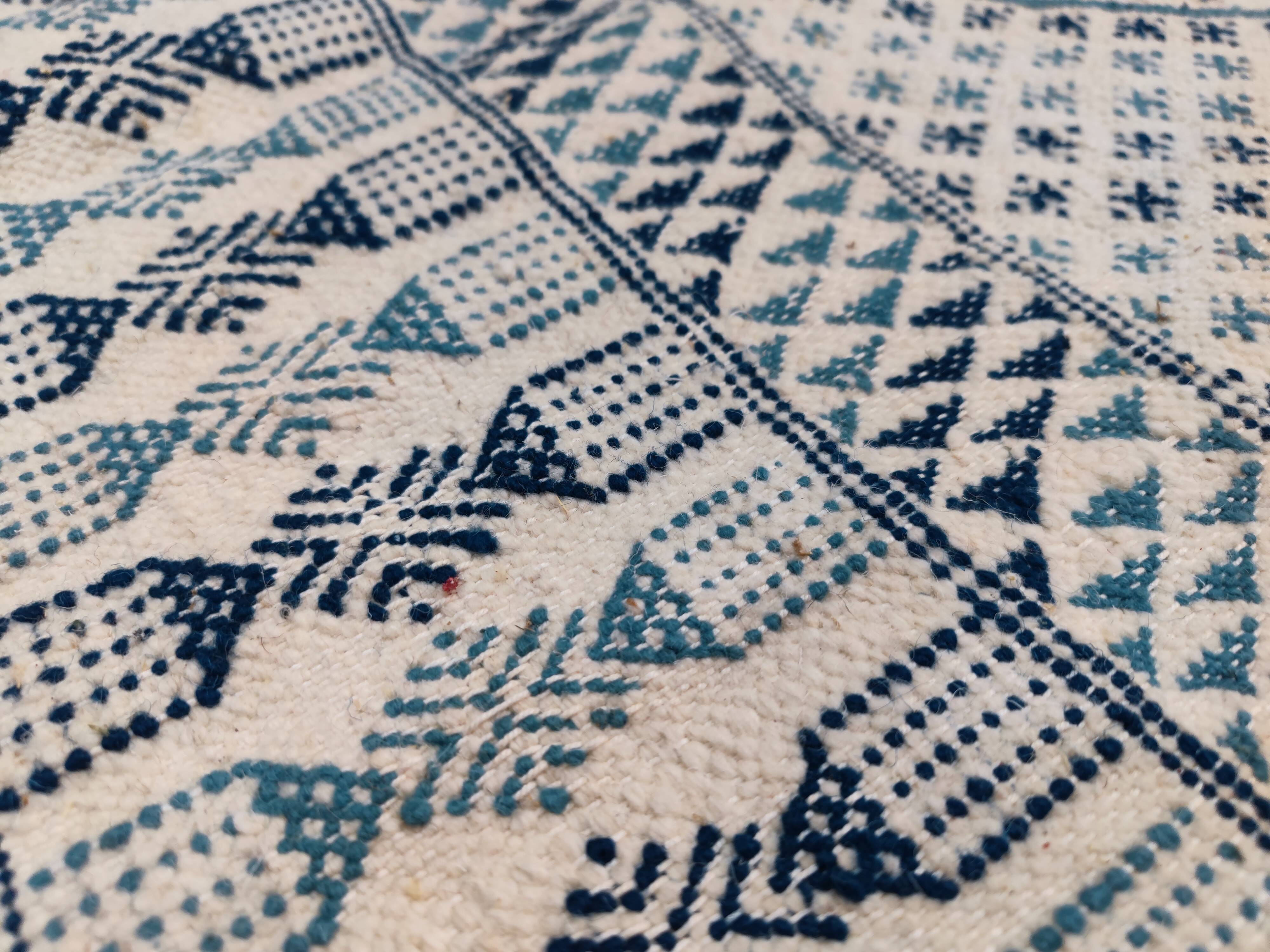 White and blue handwoven rug in natural wool