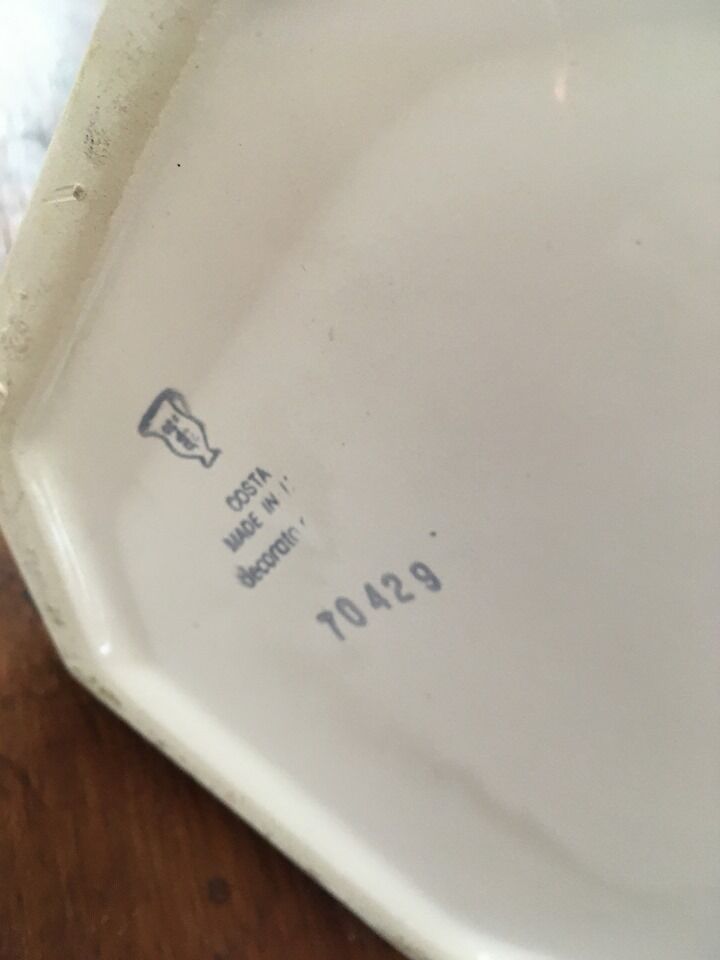 Cover - white ceramic pot decorated with stylized flowers.