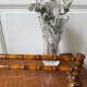Wall-mounted coat rack made of turned wood in a bamboo style.