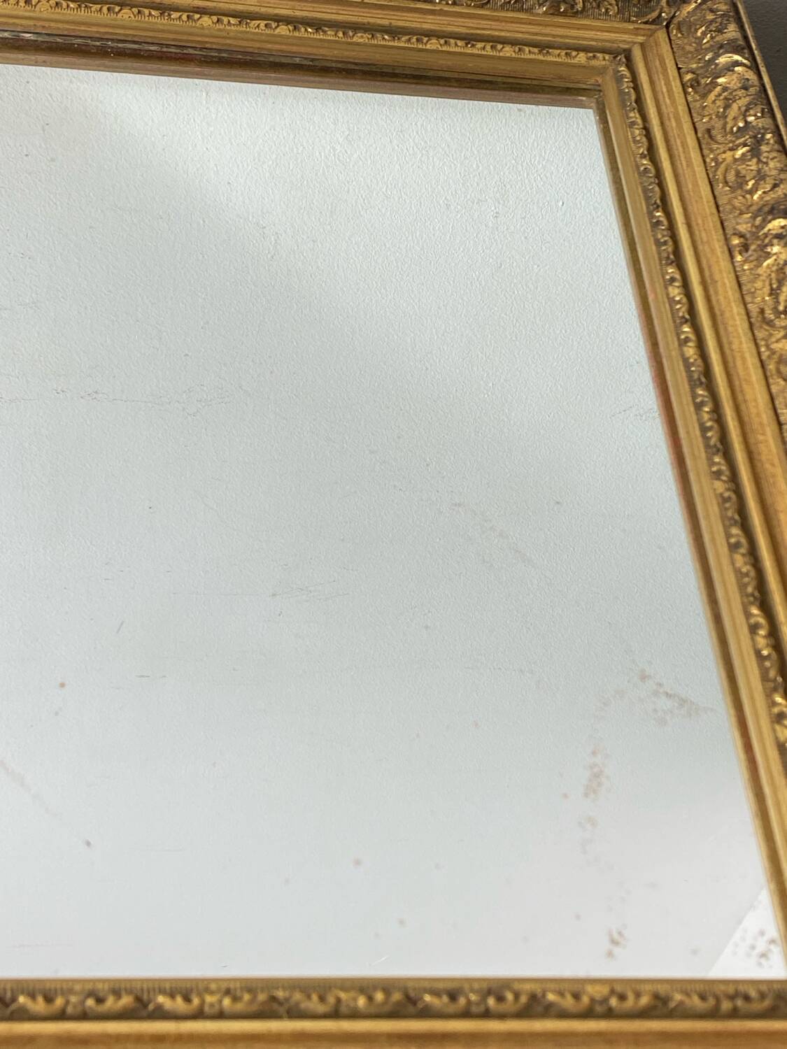 Antique mirror in carved gilded wood