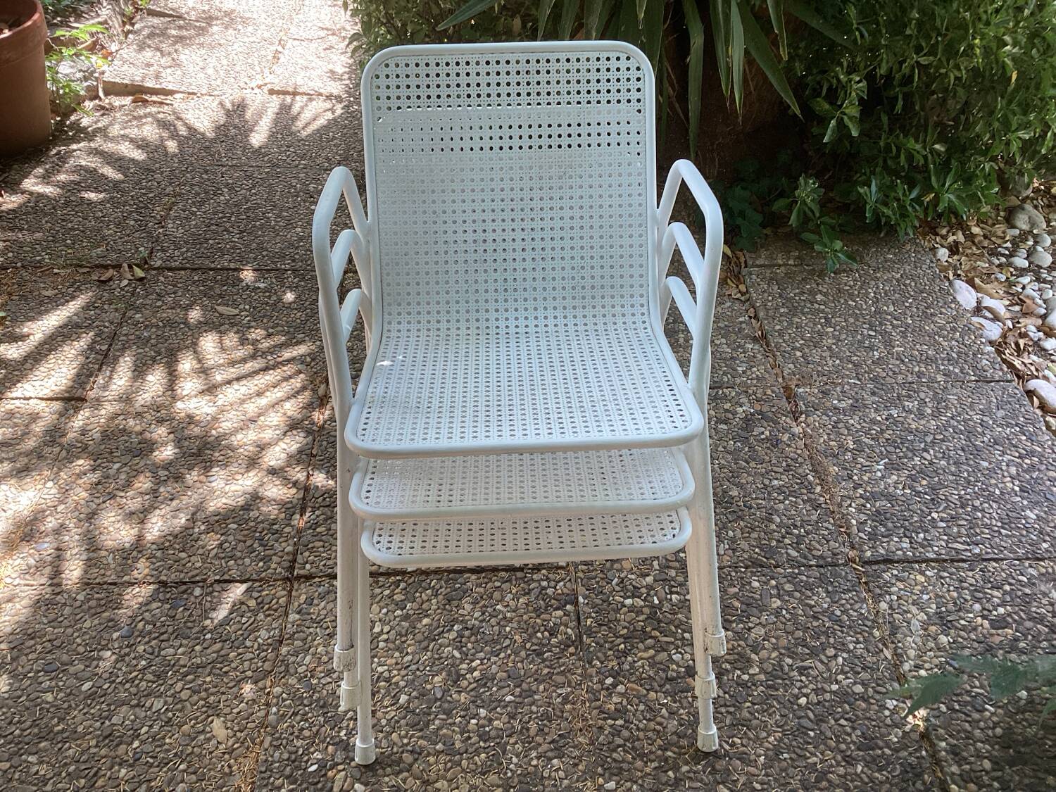 Perforated metal armchairs