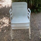 Perforated metal armchairs